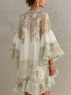 Solange | Abito corto asimmetrico in chiffon verde con volant e maniche a campana